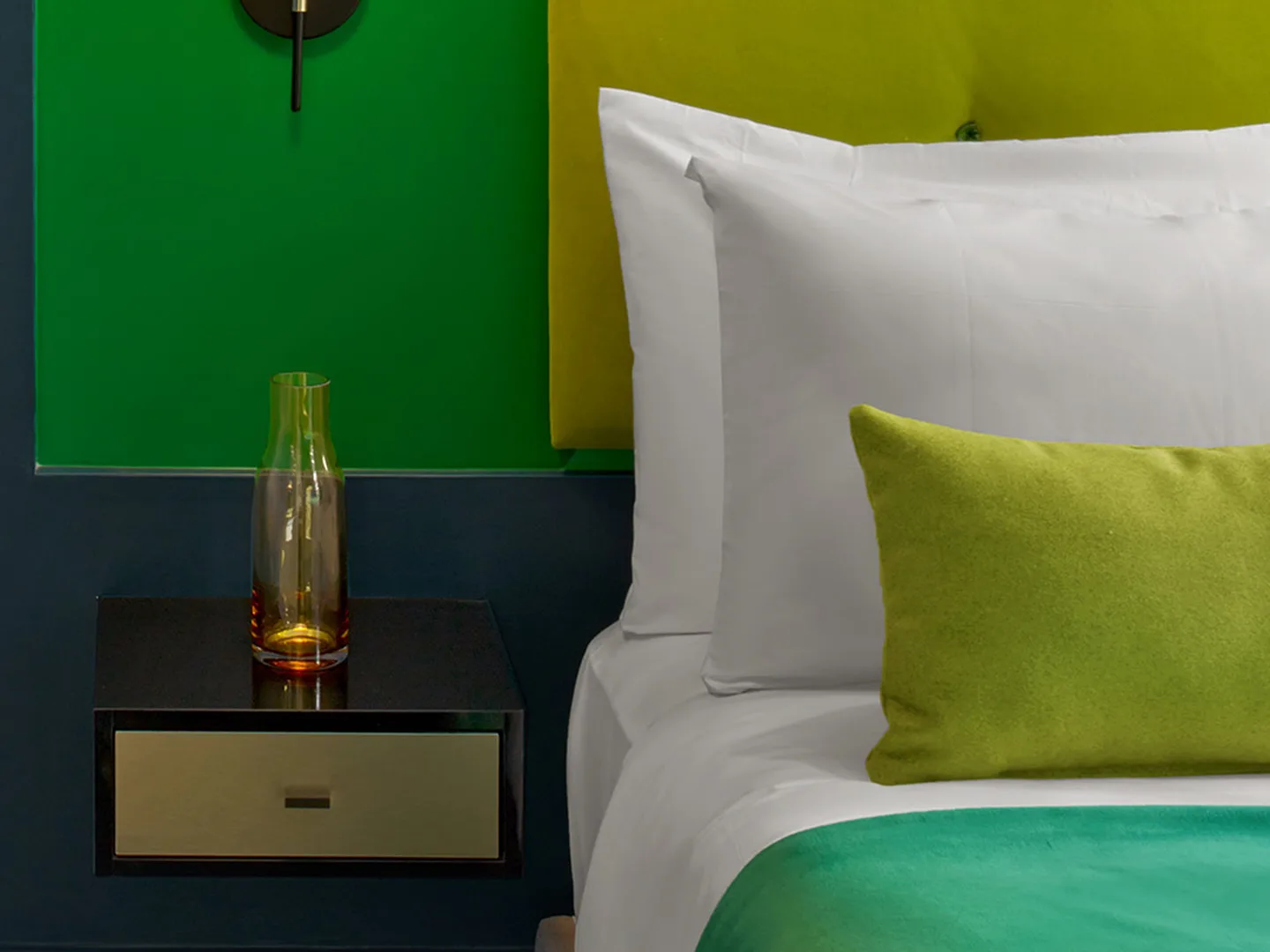 Double Room bed with lime headboard, green accent wall and floating nightstand
