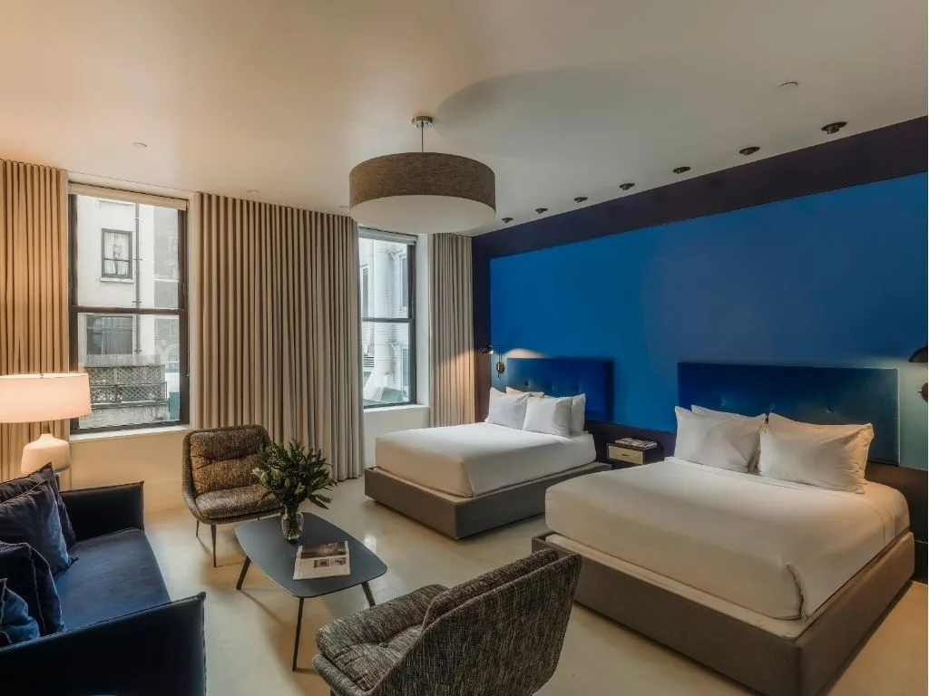 Double Room bed with lime headboard, green accent wall and floating nightstand
